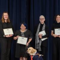 Group photo with 4 award winning professors, a professor's service dog, the GSA President and GSA Comminucations Officer